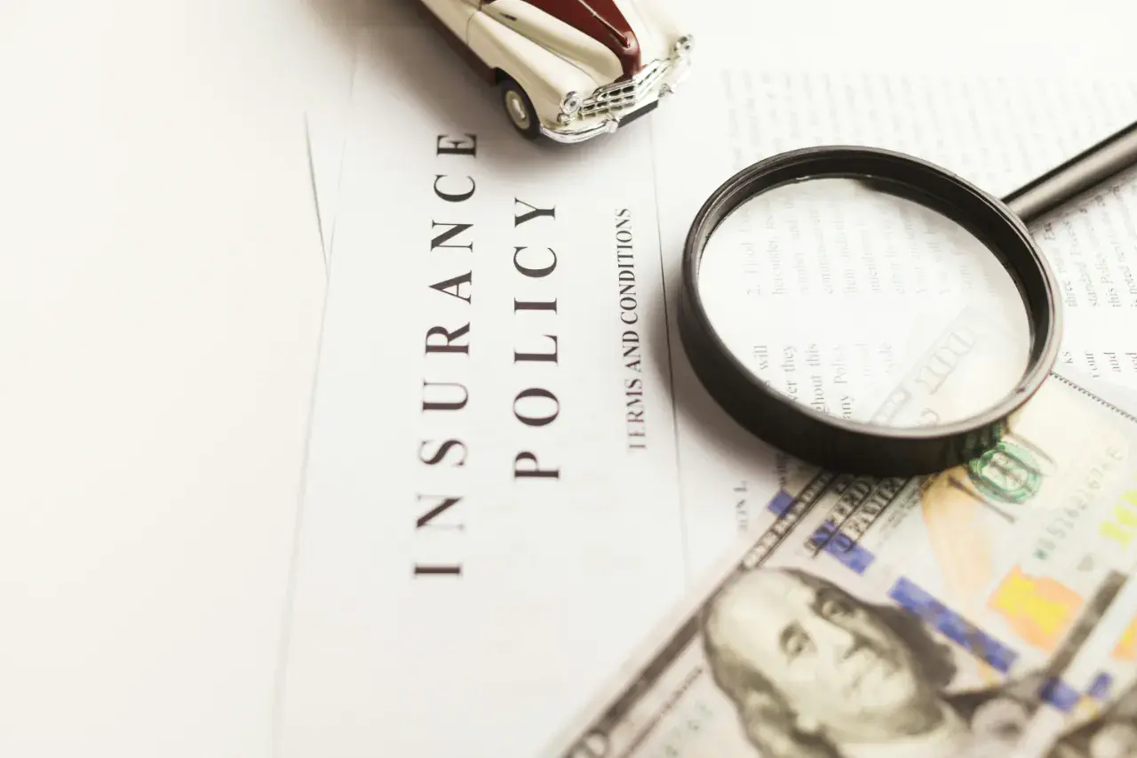 Magnifying glass on insurance documents