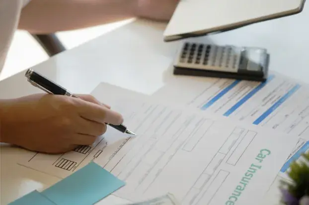 Man signing insurance policy